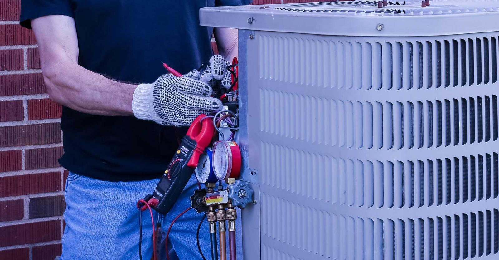Technician servicing an outdoor HVAC unit